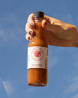 Hand Holding Papa Tony's Hot Sauce - Caribbean Crush Hot Sauce