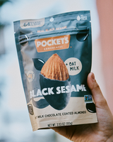 Hand holding Pocket's Chocolates - Matcha Oat Milk Almonds