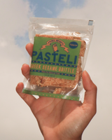 Hand holding Primis Imports - Greek Pistachio Sesame Brittle