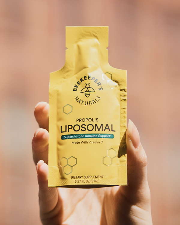 Hand holding a pouch of Beekeeper's Naturals Propolis Liposomal Immune Support. 