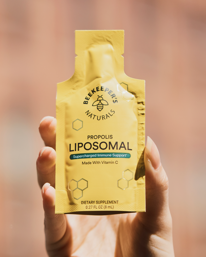 Hand holding a pouch of Beekeeper's Naturals Propolis Liposomal Immune Support. 