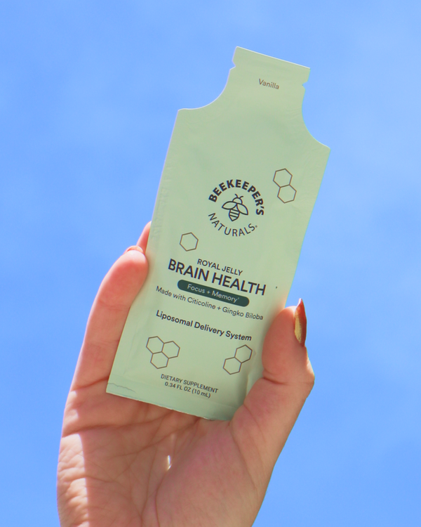 Hand holding a pouch of Beekeeper's Naturals Royal Jelly Brain Health. 