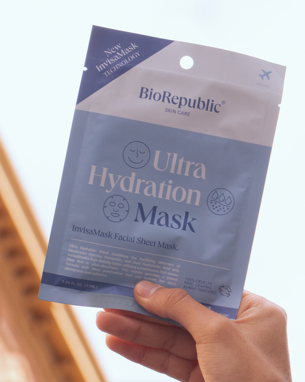 Hand holding a BioRepublic Ultra Hydration Mask package against a blurred background.