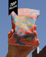 Hand holding a package of Bon Bon's 'Sweet Wild Strawberry Fish' with a blue sky background and a 'Top Seller' banner.