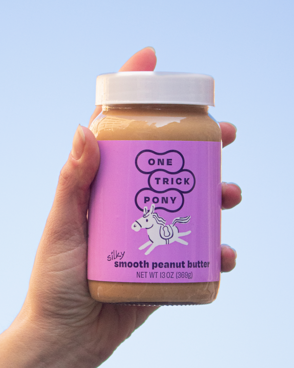 Hand holding One Trick Pony - Silky Smooth Peanut Butter
